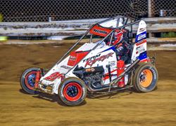 NEUMAN SURVIVES MARION MAYHEM, WIN