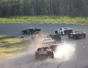 They were successfully making it around corner 1 three wide when further back, #71 Jay McCoy and #75 Dennis Aho tangled at the end of the front stretch